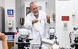 Associate Professor Will Rivers conducts an experiment in the Biology lab.