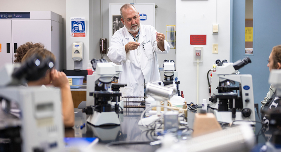 Associate Professor Will Rivers conducts an experiment in the Biology lab.