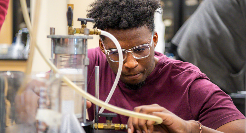 A Civil Engineering Technology student works on water filtration.