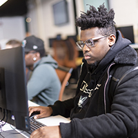 A student works at a computer in the Information Technology lab.