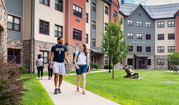 Students walk across campus from Kennedy Hall at SUNY Canton.