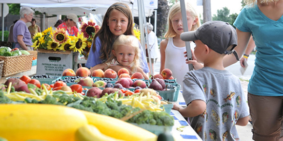 Children check out the fruits and vegetables available at the Canton Farmer's Market in downtown Canton.