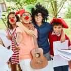 Students dressed up for a performance, hug and hold a guitar.