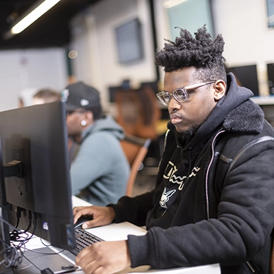 A student works on a computer in the Network Security lab.