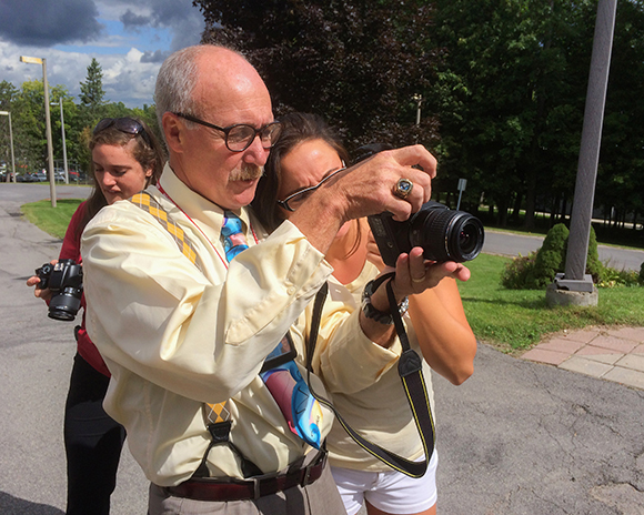 SUNY Canton Professor Emeritus William J. Fassinger teaches a student how to take crime scene photographs for the college’s Criminal Investigation program.