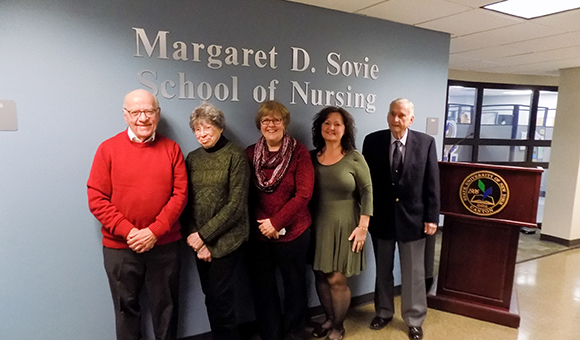 William and Carol Doe, and Sovie family friends Mary and Deborah Polniak and William Barr pose in front of the new signage outside the nursing labs.