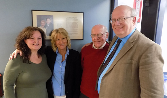 Deborah Polniak, Peggy Levato, William Doe, and President Zvi Szafran pose in front of a display featuring Al and Margaret Sovie.