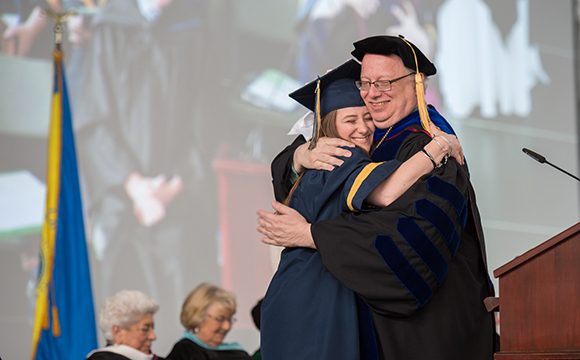 President Szafran hugs SGA President 