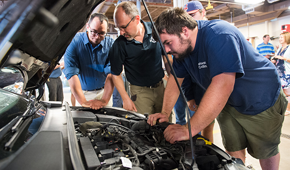 Brandon Baldwin shows students the Ford Focus engine.