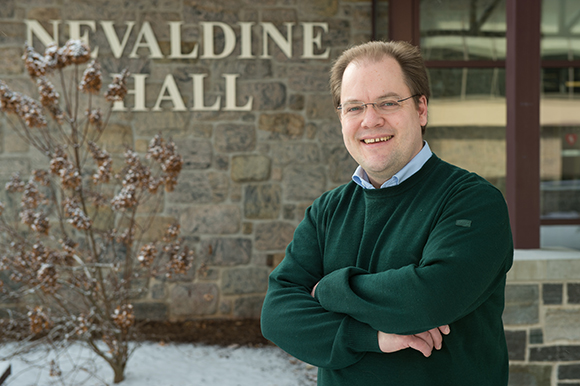 Fulbright scholar Johannes Brombach stands in front of Nevaldine Hall