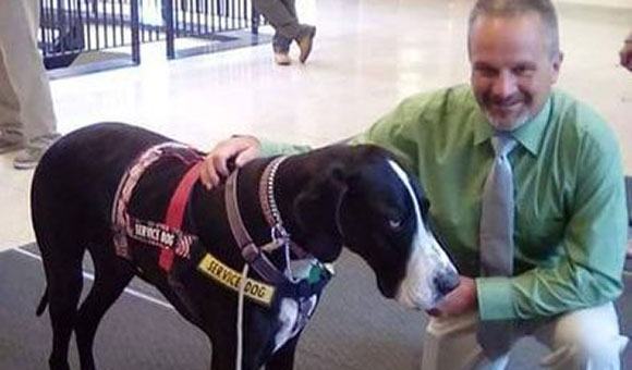 Scott Aubin with a service dog