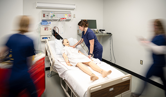 Students work in the hospital simulation lab.