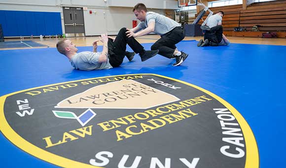 Academy Cadets Lochlan Bower and Brian Hanlin during a defensive tactics class in the Dana Hall gym.
