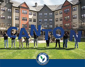 Viewbook 2025: Students holding blue CANTON letters in front of Kennedy Hall.