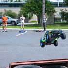 Three students launch an RC car off a ramp.