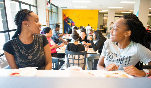 Students laugh and enjoy lunch at Rendezvous