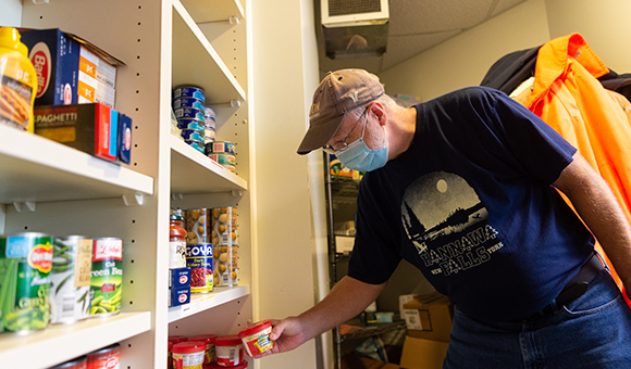 SUNY Canton United University Professions President James L. Hamilton helps restock the Renzi Food Pantry with donations during the fall 2020 semester.