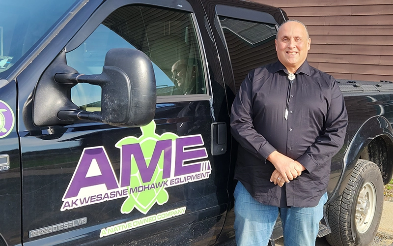 Andre White stands next to his AME branded truck.