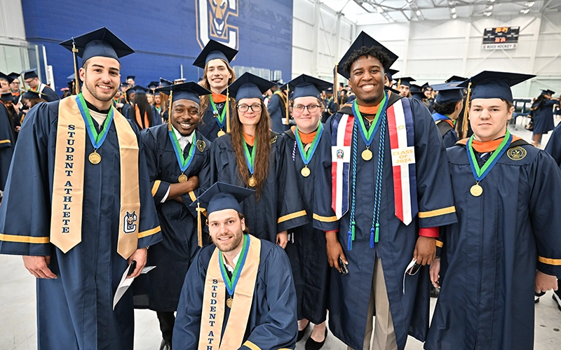 A group of diverse students poses for a photo prior to the Commencement 2024 ceremony.