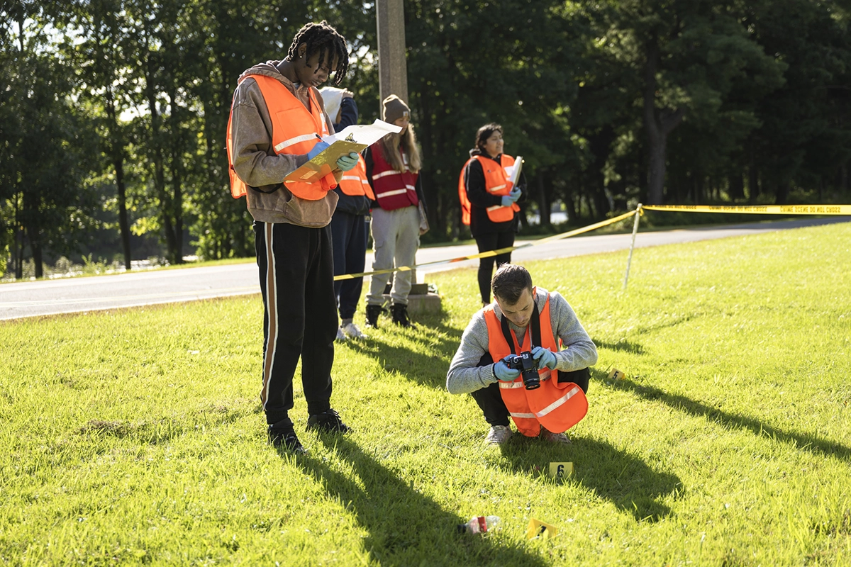 Students gather evidence from a mock crime scene.