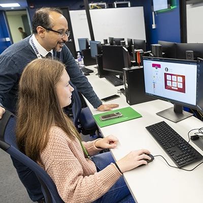 Professor Kambiz Ghazinour works with a student using the Cyber Shield platform.