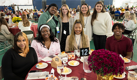 Students and donors happily gathered around a round table at Scholarship Luncheon 2024.