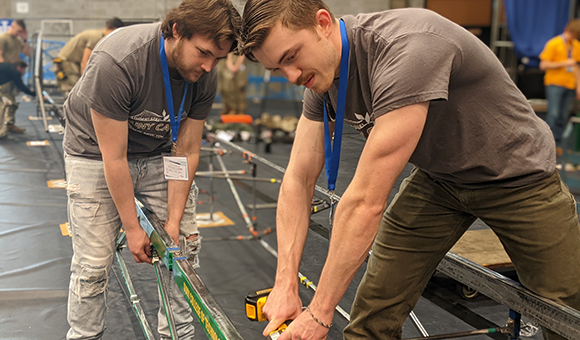 Dominic Hauptman and Raiden Hansen assembling the bridge at the American Institute of Steel Construction Upstate New York – Canada regional competition.