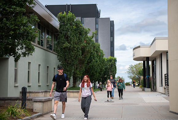 Students walking in the plaza on a sunny day.