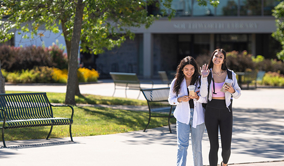 Two students walk in the Roselle Plaza near Southworth Library.