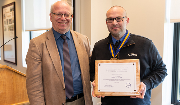 President Zvi Szafran presents Lucas Craig with the Chancellor's Award.