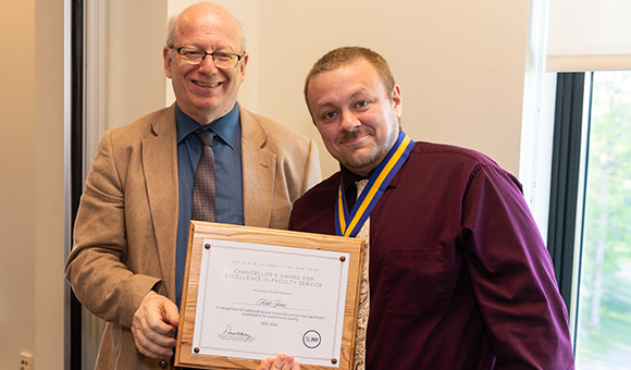 President Zvi Szafran presents Kirk Jones with the Chancellor's Award.