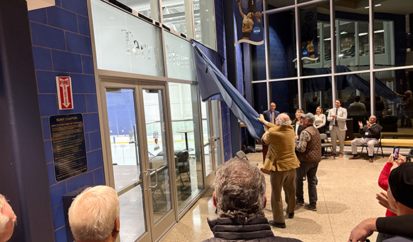 President Szafran and Terry Martin tear down the covering to unveil the new Terry Martin Arena signage.