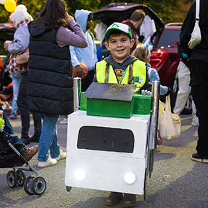A Trunk or Treat participant dressed in a handcrafted cardboard tractor trailer costume.