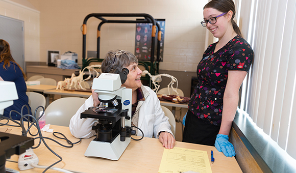 Program Director Mary Loomis helps Jessica Knapp analyze samples in the Newell Veterinary Technology Center