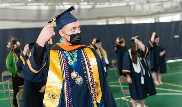 Vincent VanBrocklin of Watertown flips his tassel to signify that he has graduated at SUNY Canton’s 2020 Commencement Ceremony.