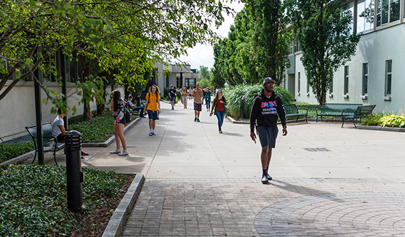 Students walk between Payson and Cook Halls at SUNY Canton