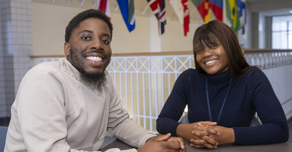 Cameroonian students Yvan and Endale sit at a table outside the Ready Center.
