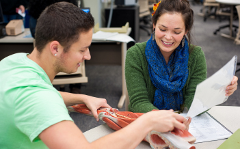 Two students study human anatomy in the Tutoring Center.